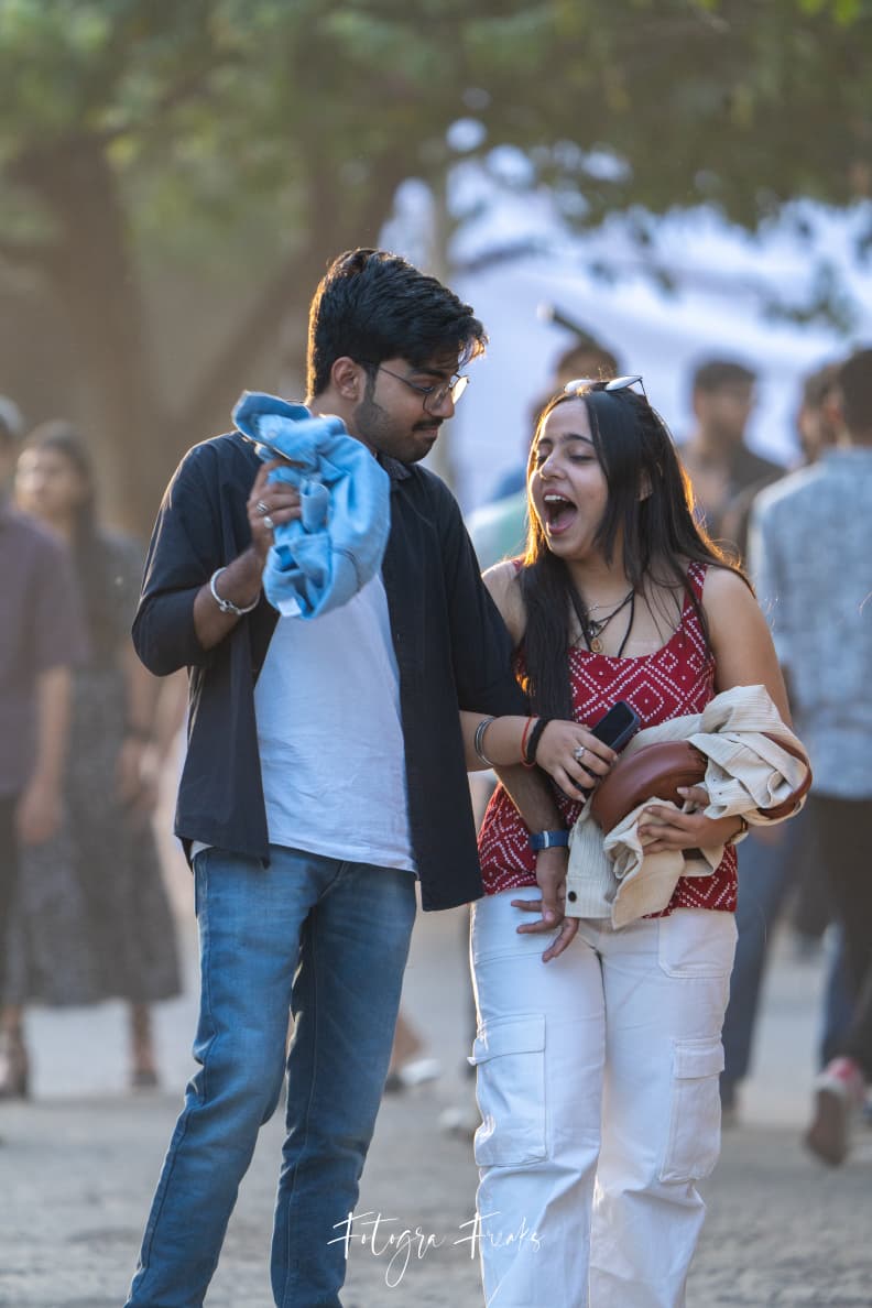 Nishu laughing while we stand together outdoors.